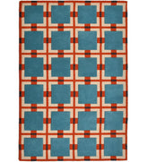 Hand-tufted wool rug with retro geometric grid pattern in teal blue, rust red, and ivory.